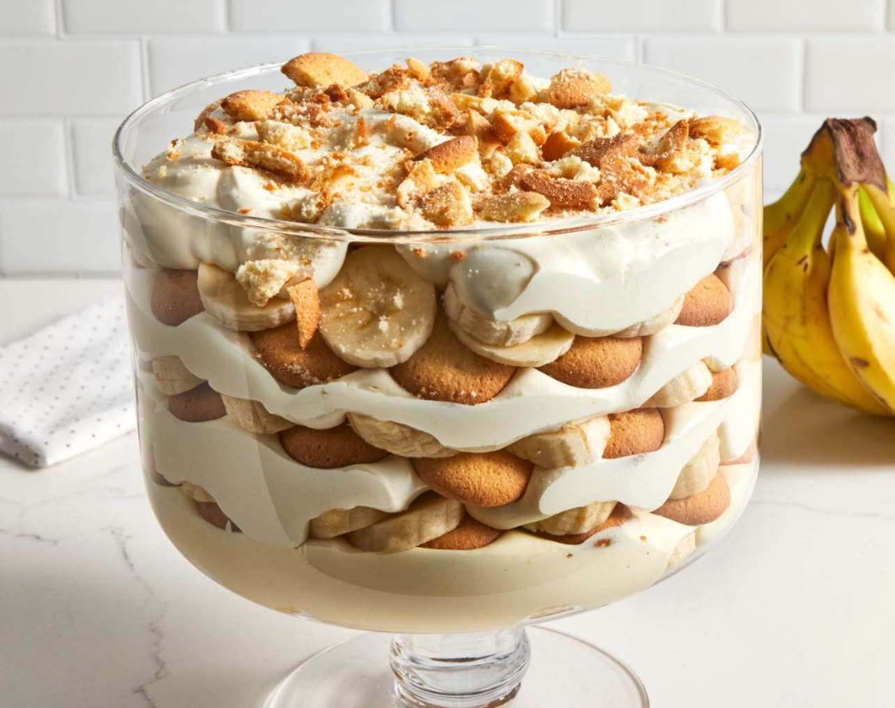 Layered banana pudding served in a clear glass cup