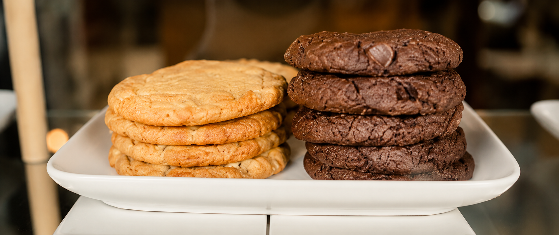 Homemade chocolate chip cookies served beside a cup of coffee